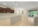 Open kitchen with brown cabinetry, tile floors, and lots of natural light streaming through the sliding glass doors at 2920 Oriole Dr, Sarasota, FL 34243
