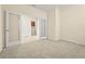 Open living room with neutral walls, and access to an adjoining laundry room through glass french doors at 2920 Oriole Dr, Sarasota, FL 34243
