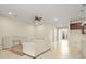 Spacious living room featuring tile flooring, modern light fixtures, and a decorative fan at 2920 Oriole Dr, Sarasota, FL 34243