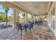 Outdoor seating area with tables and chairs adjacent to the pool, perfect for relaxing and dining at 2920 Oriole Dr, Sarasota, FL 34243