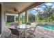 Covered patio area with comfortable seating and views of the sparkling pool and backyard at 2920 Oriole Dr, Sarasota, FL 34243