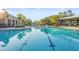 Large community swimming pool with clear blue water, lounge chairs, and palm trees at 2920 Oriole Dr, Sarasota, FL 34243