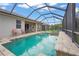 Enjoy outdoor living with a screened-in pool, spa, and spacious patio, ideal for gatherings and relaxation at 2920 Oriole Dr, Sarasota, FL 34243