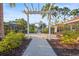 Well-maintained walking path with lush landscaping and seating areas for residents at 2920 Oriole Dr, Sarasota, FL 34243