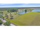 Beautiful waterfront property with a home, lake, and sprawling green fields at 29527 Leah Rd, Punta Gorda, FL 33982