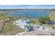 Expansive aerial view showcasing the light-blue house and pristine landscaping on a waterfront property at 29527 Leah Rd, Punta Gorda, FL 33982