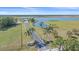 Picturesque estate featuring a long driveway, pond, and sprawling green fields at 29527 Leah Rd, Punta Gorda, FL 33982