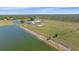 Stunning aerial view of an estate with a pond, vast green land, and a well-maintained home at 29527 Leah Rd, Punta Gorda, FL 33982