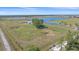 Picturesque aerial view of a large property with lush greenery and a tranquil lake at 29527 Leah Rd, Punta Gorda, FL 33982