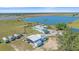 Stunning aerial view of a lakefront property with a spacious home and a large outbuilding for RV parking at 29527 Leah Rd, Punta Gorda, FL 33982