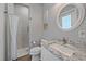 Well-lit bathroom with white vanity, granite countertop, and tiled walk-in shower at 29527 Leah Rd, Punta Gorda, FL 33982