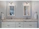 Bathroom vanity featuring double sinks, granite countertops, and white cabinets at 29527 Leah Rd, Punta Gorda, FL 33982