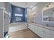 This is a bathroom with a tub and a vanity with two sinks at 29527 Leah Rd, Punta Gorda, FL 33982