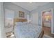 Comfortable bedroom featuring neutral colors, seaside decor, and access to an ensuite bathroom at 29527 Leah Rd, Punta Gorda, FL 33982