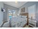 Bright bedroom featuring patio door access to a screened pool with backyard views at 29527 Leah Rd, Punta Gorda, FL 33982