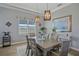 Charming dining room with a large table, elegant light fixtures, and bright natural light at 29527 Leah Rd, Punta Gorda, FL 33982