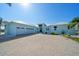Charming blue single-story home with a three-car garage and brick driveway at 29527 Leah Rd, Punta Gorda, FL 33982