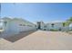 Charming blue single-story home with a three-car garage and brick driveway at 29527 Leah Rd, Punta Gorda, FL 33982