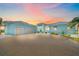 Attractive two-story home showcasing a spacious driveway leading to an attached three-car garage at 29527 Leah Rd, Punta Gorda, FL 33982