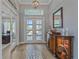 Bright foyer boasts a high ceiling, transom window, decorative rug and charming cabinet at 29527 Leah Rd, Punta Gorda, FL 33982