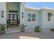 Inviting home entrance with decorative potted plants and a stylish front door at 29527 Leah Rd, Punta Gorda, FL 33982