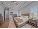 A peaceful bedroom with wood floors, tray ceilings, and modern decor at 29527 Leah Rd, Punta Gorda, FL 33982