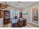 Office features a large desk, built-in shelving, and a large window for natural light at 29527 Leah Rd, Punta Gorda, FL 33982