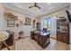 Spacious office with tray ceiling, large desk, built in shelving, and large window at 29527 Leah Rd, Punta Gorda, FL 33982