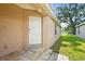 Image of white back door with brick paver steps leading to a well-maintained lawn and landscaping at 3362 Howell Pl, Sarasota, FL 34232