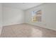 Bright bedroom with tile flooring, natural light, and neutral paint at 3362 Howell Pl, Sarasota, FL 34232