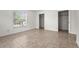A bright bedroom featuring tile floors, closet space and a sunlit window at 3362 Howell Pl, Sarasota, FL 34232