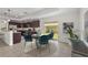 Modern dining area with a stylish round table and chairs, adjacent to the kitchen and patio at 3362 Howell Pl, Sarasota, FL 34232
