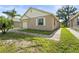 Charming single-story home with a brick paver driveway and well-maintained lawn and front window at 3362 Howell Pl, Sarasota, FL 34232