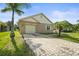 Charming single-story home with a brick paver driveway and well-maintained lawn with a palm tree in front yard at 3362 Howell Pl, Sarasota, FL 34232