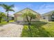 Charming single-story home with a brick paver driveway and well-maintained lawn with two palm trees in front yard at 3362 Howell Pl, Sarasota, FL 34232