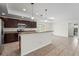 Open kitchen view with granite countertops, dark cabinets, and modern stainless steel appliances at 3362 Howell Pl, Sarasota, FL 34232