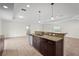 Kitchen island boasts granite countertops and dark cabinets, perfect for meal preparation and entertaining at 3362 Howell Pl, Sarasota, FL 34232