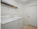 Laundry room with washer, dryer, and utility shelf at 3362 Howell Pl, Sarasota, FL 34232