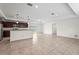 Open-concept kitchen and living area with a breakfast bar, stainless appliances, and tile flooring at 3362 Howell Pl, Sarasota, FL 34232