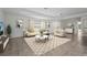 Bright open-concept living room with modern decor, tile flooring, and large area rug at 3362 Howell Pl, Sarasota, FL 34232