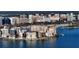 Stunning aerial view showcasing waterfront property with city skyline and marina in the background at 350 Golden Gate Pt # 61, Sarasota, FL 34236