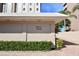 Exterior view of building entrance with address number and manicured landscaping at 350 Golden Gate Pt # 61, Sarasota, FL 34236