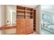 Spacious walk-in closet with wood shelves and drawers next to the main bedroom at 350 Golden Gate Pt # 61, Sarasota, FL 34236