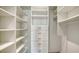 Organized walk-in closet featuring ample shelving and drawers, maximizing storage space at 350 Golden Gate Pt # 61, Sarasota, FL 34236