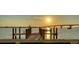 Scenic view of a waterfront dock bathed in the warm glow of the setting sun at 350 Golden Gate Pt # 61, Sarasota, FL 34236