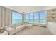 Bright living room with ample seating, floor to ceiling windows and serene water views at 350 Golden Gate Pt # 61, Sarasota, FL 34236