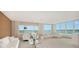 Bright living room with ample seating, floor to ceiling windows and serene water views at 350 Golden Gate Pt # 61, Sarasota, FL 34236