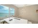 Bright office with a modern desk, comfortable chair, lots of natural light, and water views at 350 Golden Gate Pt # 61, Sarasota, FL 34236