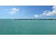 Calm water view with boats gliding along the serene blue water on a bright sunny day at 350 Golden Gate Pt # 61, Sarasota, FL 34236