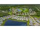 A stunning aerial view shows homes positioned near a serene lake and golf course enveloped in greenery at 3621 Wild Blossom Pl, Parrish, FL 34219
